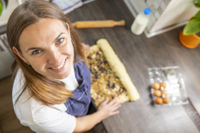 Portrait of smiling young woman sitting on table