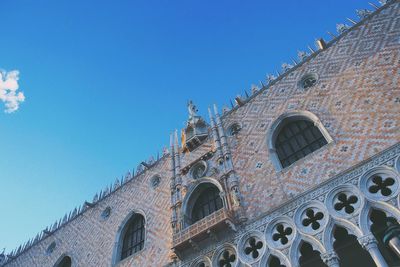 Low angle view of built structure against clear blue sky