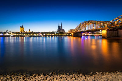 View of bridge over river at night