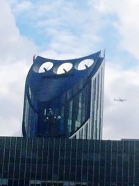 Low angle view of building against cloudy sky