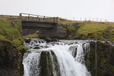 Scenic view of waterfall against sky