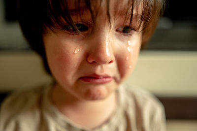 A big rubbing of a crying boy. emotions