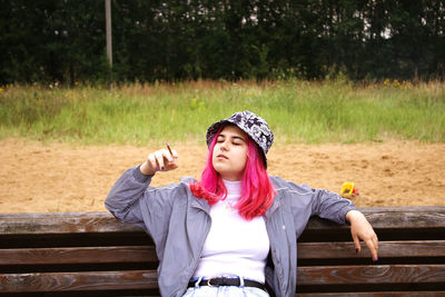 Portrait of woman sitting on bench