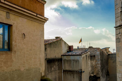 Buildings against cloudy sky