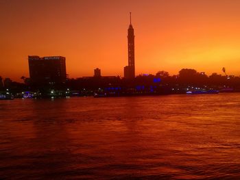 Buildings in city during sunset