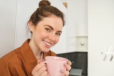 Young woman using mobile phone at home