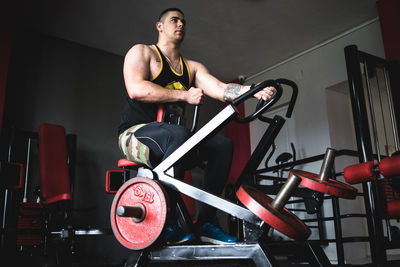 Young man exercising in gym