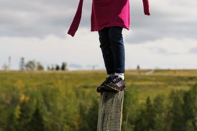 Low section of person standing on field