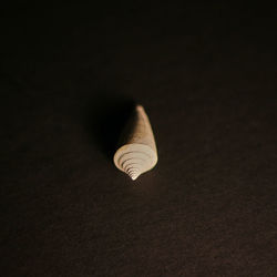 Low angle view of light bulb against black background