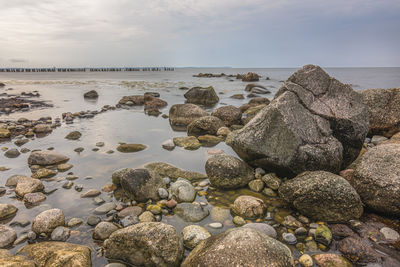 Rocks on beach against sky
