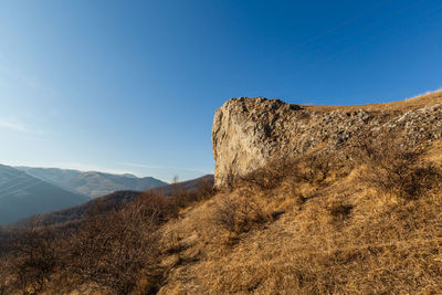 Scenic view of mountain against blue sky