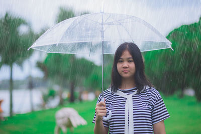 Portrait of woman standing on wet rainy day