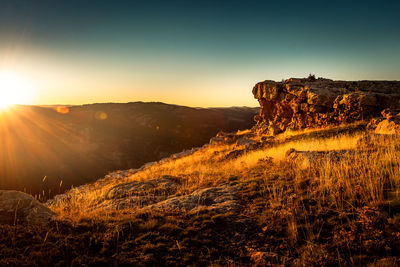 Scenic view of mountains against sky at sunset