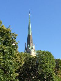 Low angle view of built structure against clear blue sky