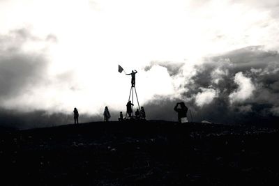 Men on cloudy sky