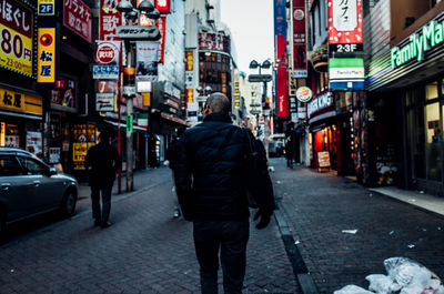 Rear view of man walking on street