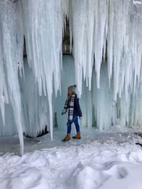 Full length of woman walking by icicles