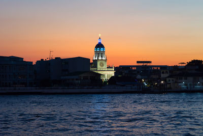 Bangkok santa cruz church on the chaopraya river bank during twilight time.