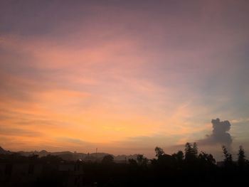 Silhouette trees against sky during sunset