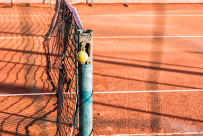 Tennis ball on pole of net