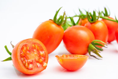 Close-up of tomatoes against white background