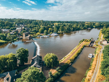 High angle view of river amidst trees against sky