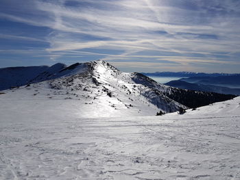 Scenic view of snow covered mountains against sky