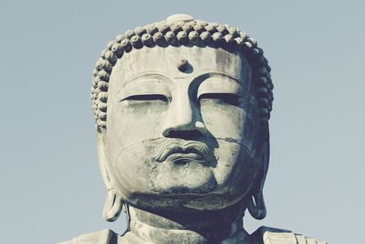 Low angle view of great buddha against sky