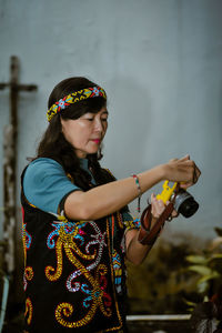 Side view of young woman using mobile phone