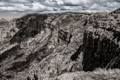 Scenic view of mountains against cloudy sky