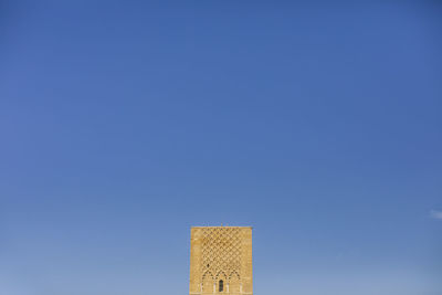 Close-up of modern building against blue sky