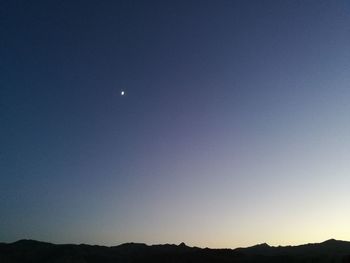 Scenic view of mountains against clear blue sky