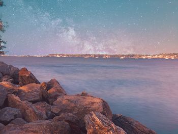 Scenic view of sea against sky at night