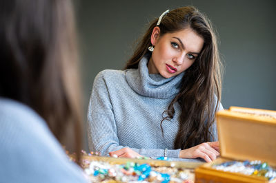 Portrait of beautiful woman sitting on table