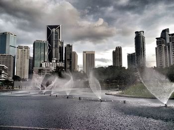 Buildings against cloudy sky