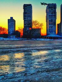 Buildings in city at sunset