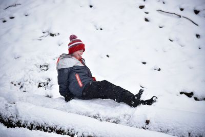 Full length of child playing in snow