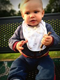 Cute baby boy sitting outdoors