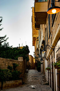 Narrow street amidst buildings against sky