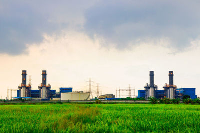 View of factory against cloudy sky