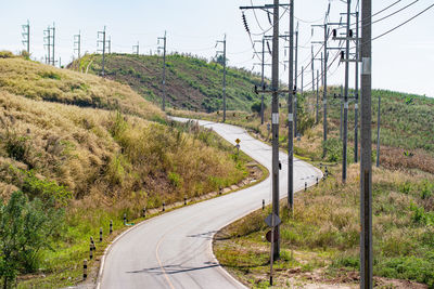 Road amidst trees against sky