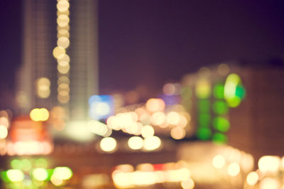 Defocused image of illuminated city at night