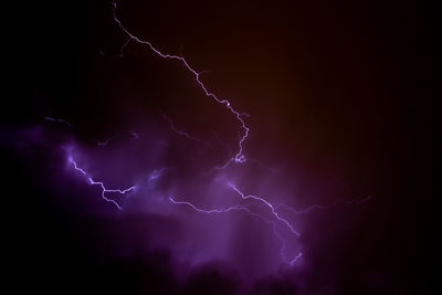 Low angle view of lightning against sky at night