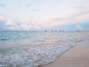 Scenic view of beach against sky during sunset