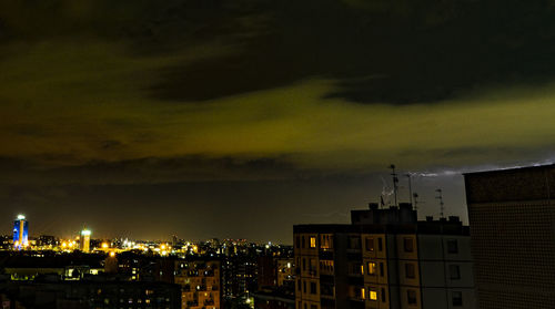 High angle view of buildings in city at night