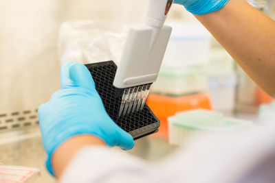 Cropped hands of scientist experimenting in laboratory