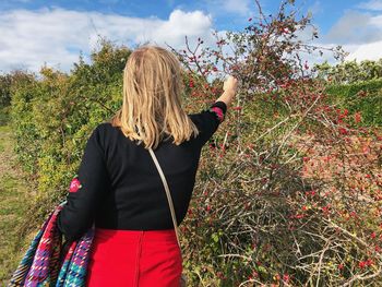 Rear view of woman standing by plants