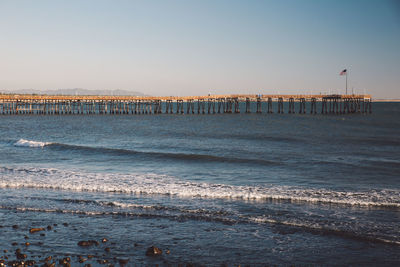 Scenic view of pier over sea against clear sky