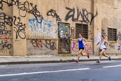 Female runners training in industrial area of brooklyn