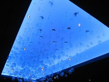 Low angle view of illuminated building against sky